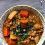 A bowl of Vegetable and Chickpea Broth topped with herbs