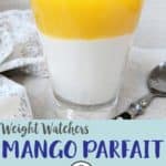 A glass of mango parfait topped with pomegranate seeds