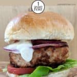 A turkey burger in a bun with lettuce and mayo