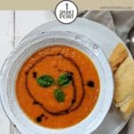 A bowl of tomato soup with a drizzle of balsamic vinegar