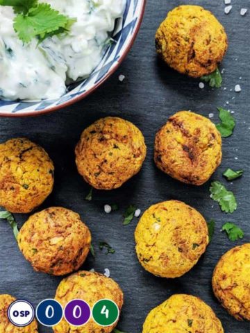 Falafels on a slate board with some tzatziki