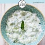 A bowl of tzatziki on a white table