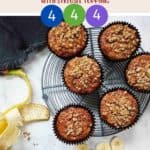 Banana Muffins on a wire rack with a peeled banana along side