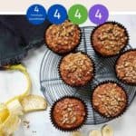 Banana Muffins on a wire rack with a peeled banana along side