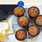 Banana Muffins on a wire rack with a peeled banana along side