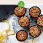 Banana Muffins on a wire rack with a peeled banana along side