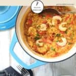 A dish of shrimp, chirizo and red pepper paella