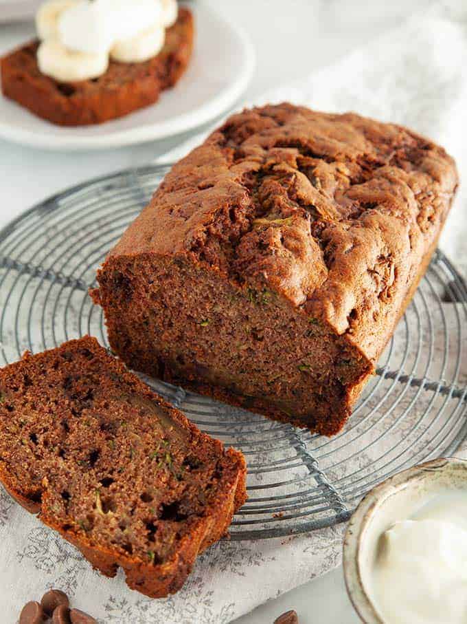 A loaf of Choc Chip Zucchini Bread on a white table