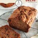 A loaf of Choc Chip Zucchini Bread on a cooling rack