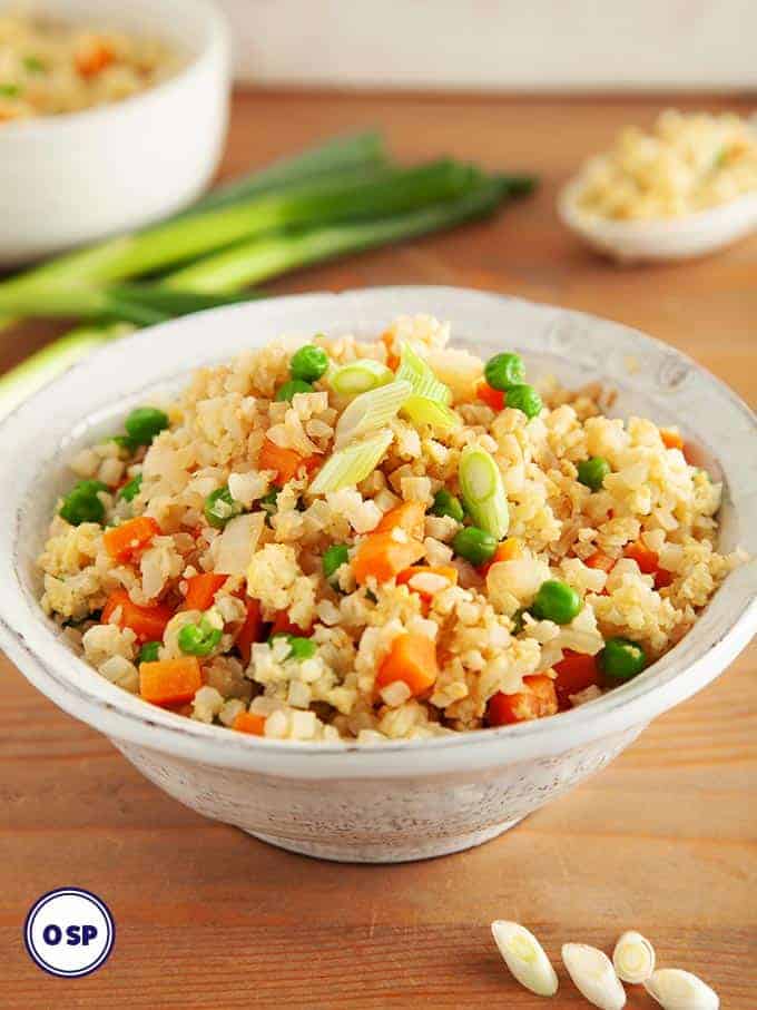 Egg fried cauliflower rice in a white bowl