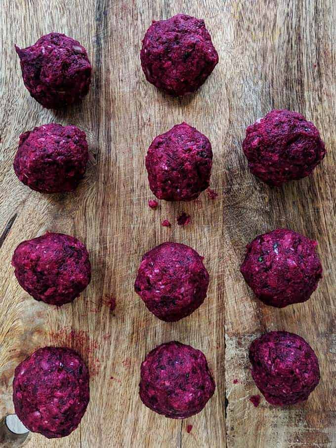 Beetroot falafels on a wooden board
