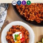 A skillet of chili on a wooden table