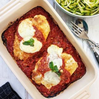 A dish of Chicken Parmesan on a white table | weight watchers