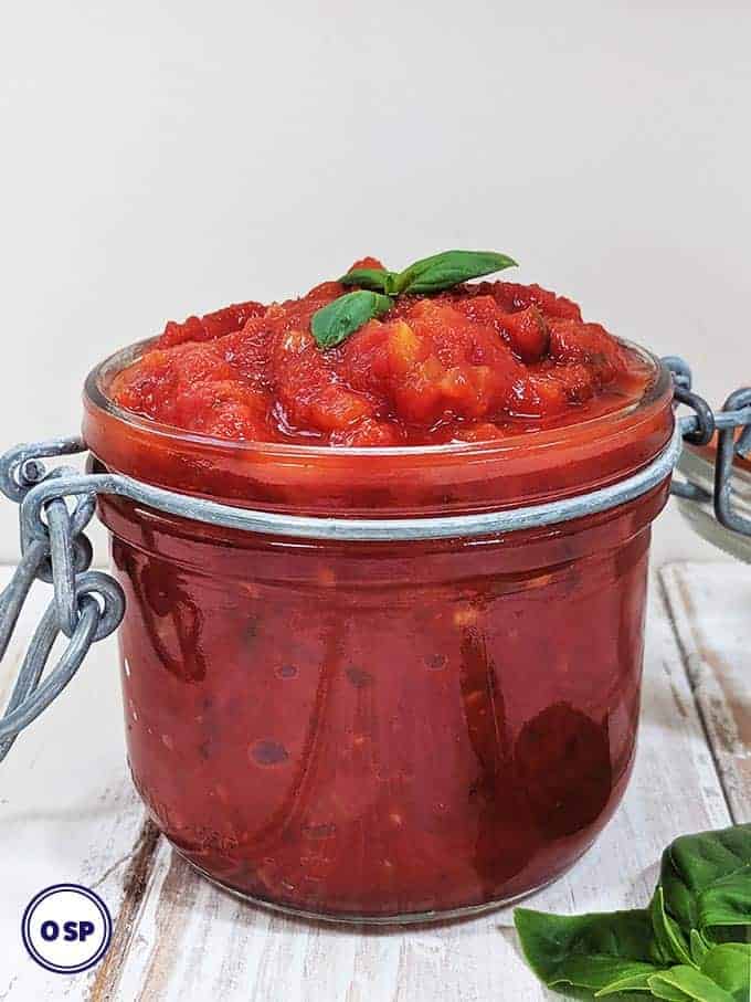 A jar of easy marinara sauce on a white table