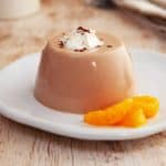 Some chocolate orange fluff on a white plate with some mandarin slices