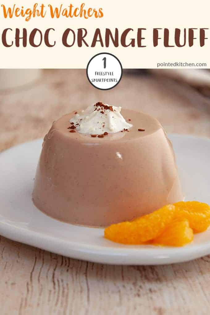 A white plate with chocolate orange fluff and some sliced mandarin slices