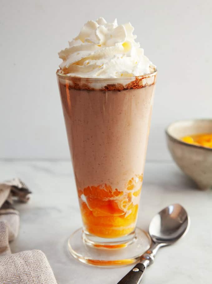 A sundae glass full of mandarin slices and chocolate orange fluff