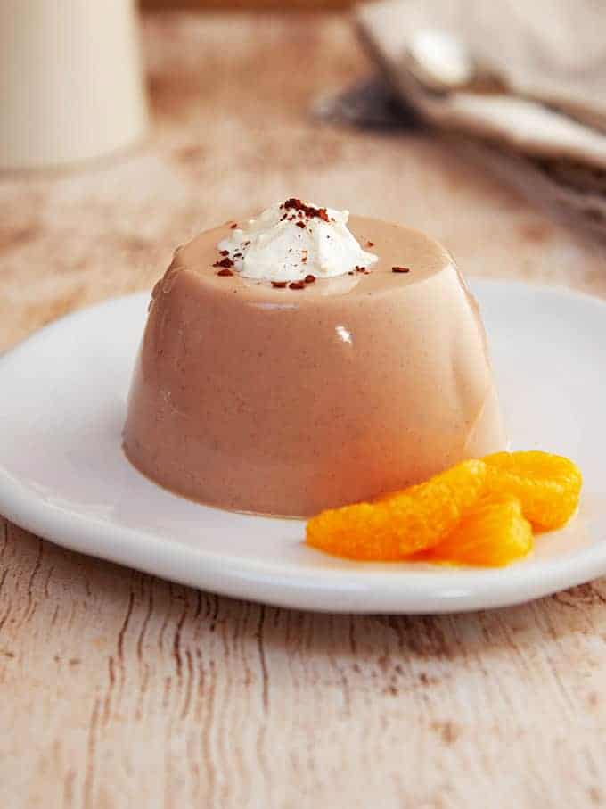 Some chocolate orange fluff on a white plate with some mandarin slices