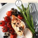 Balsamic chicken with asparagus on a white plate with cutlery