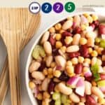 A bowl of bean salad on a white table