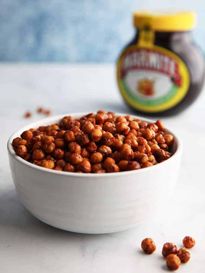 A bowl of chickpeas with a tub of marmite