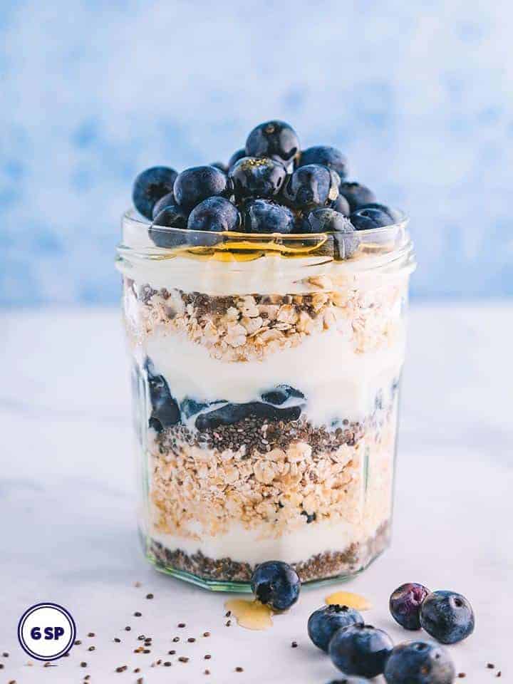 A jar of overnight oats topped with blueberries