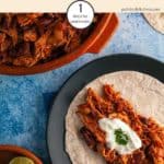 A dish of Mexican Mole on a blue table