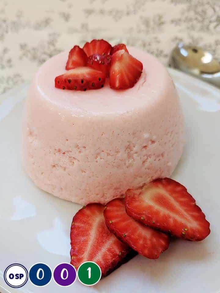 A Weight Watchers Fluff dessert on a white plate with strawberries