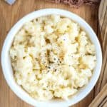A bowl of celeriac mash on a wooden table
