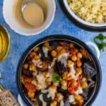 A collection of dishes of food on a blue table
