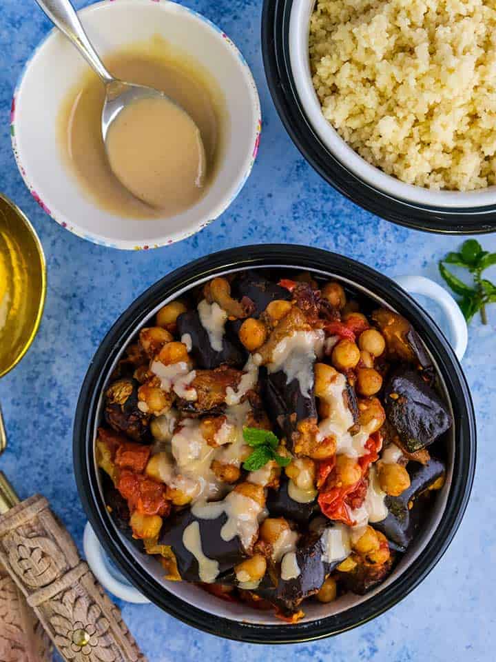 A collection of dishes of food on a blue table