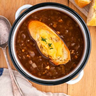 A bowl of WW French Onion Soup on a wooden table