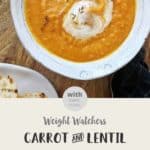 A white ceramic bowl of carrot soup