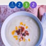 A bowl of soup on a pink table