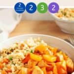 A white bowl of sweet & sour chicken with cauliflower rice on a wooden table