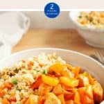 A white bowl of sweet & sour chicken with cauliflower rice on a wooden table