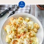 A bowl of egg salad on a white table