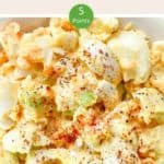 A close up of egg salad with chopped spring onions