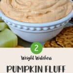 A white bowl full of pink coloured pumpkin fluff with a cookie being dipped in.