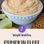 A white bowl full of pink coloured pumpkin fluff with a cookie being dipped in.