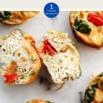 A picture of egg muffins on a white table with one cut open and text overlay stating WW Breakfast Egg muffin 1 point.