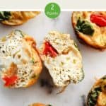 A picture of egg muffins with one cut open on a white table with a text overlay stating WW Breakfast Egg muffin 2 points..