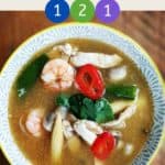 A dish of soup on a wooden table with text overlay stating 'Weight Watchers Tom Yum Soup' and the SmartPoint values