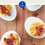 5 cheese and bacon stuffed eggs on a wooden board.