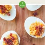 5 cheese and bacon stuffed eggs on a wooden board.