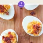 5 cheese and bacon stuffed eggs on a wooden board.