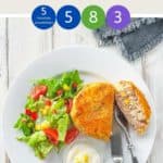 A white plate with a fishcake and some salad on a white wooden table with text overlay 'Weight Watchers Tuna Fish Cakes'.