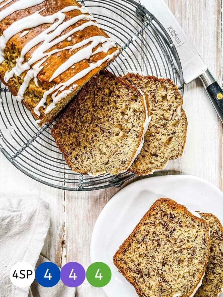 A sliced banana bread on a wire rack with colored disks showing WW smartpoint values.